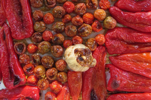 A tray of roasted peppers of different sizes.